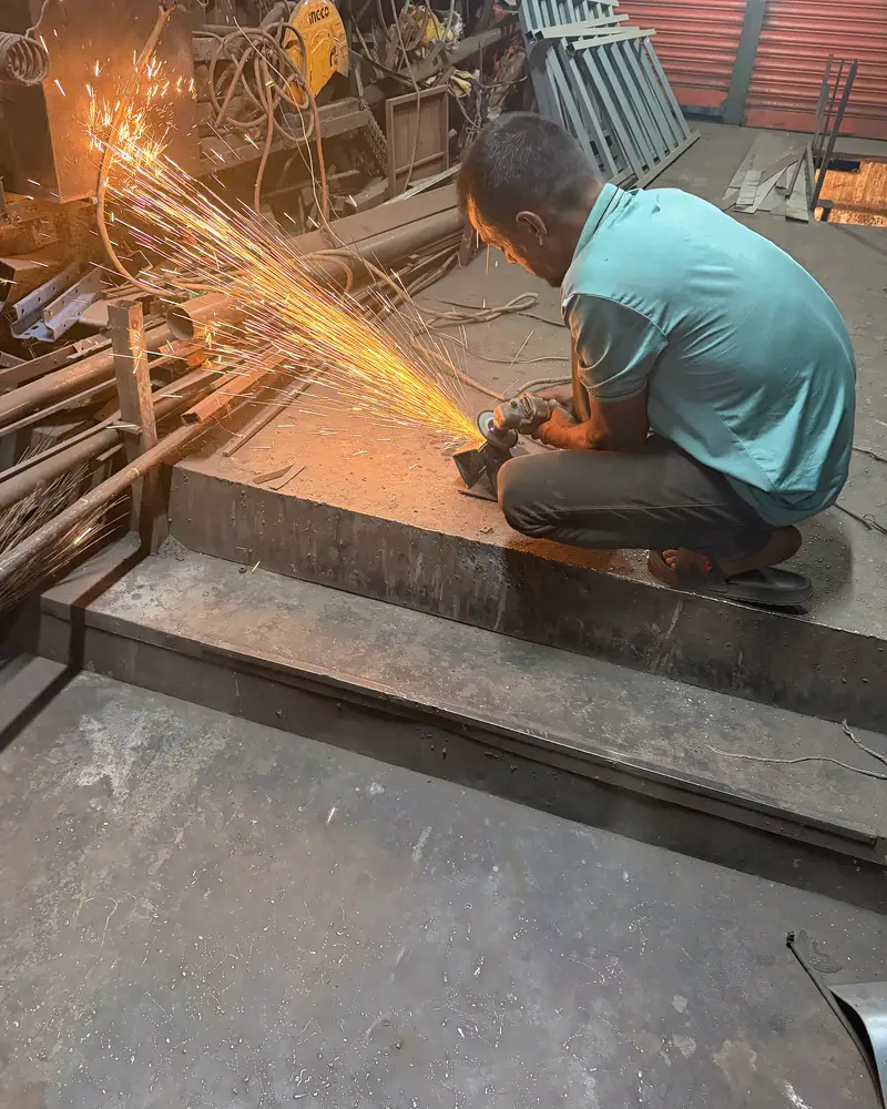 A welder cutting steel during the industrial build in Dhaka